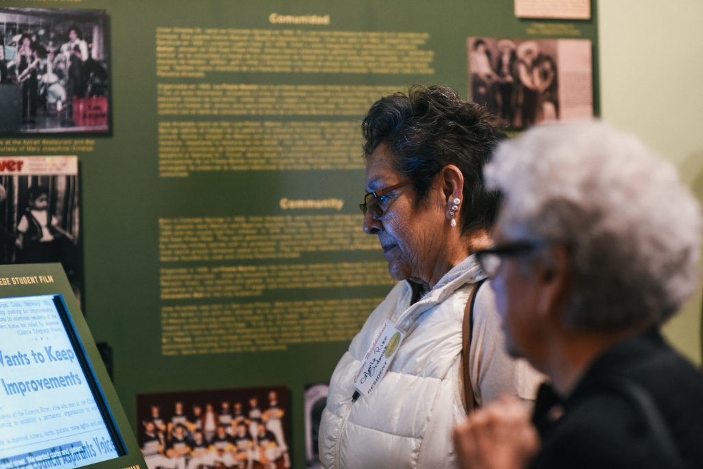 Visitors watching a video in "Una Familia Grande."