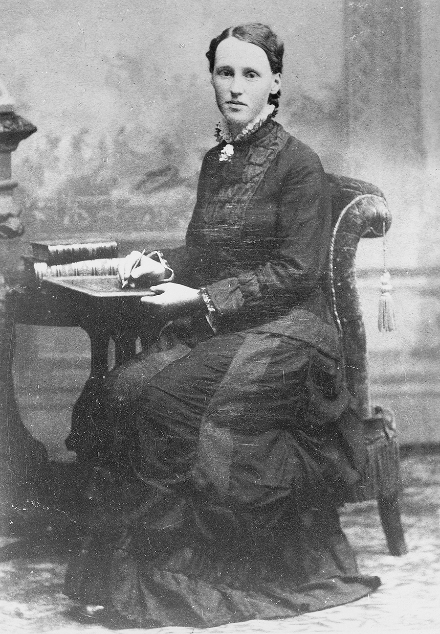 A photo of Julia A. Holmes sitting in a chair.