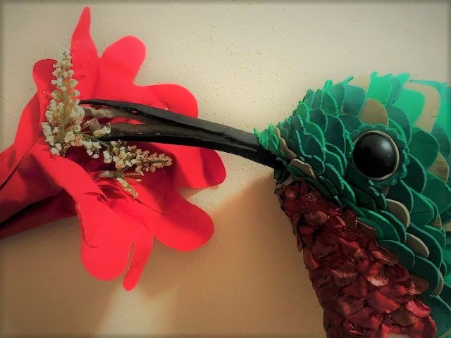 a hummingbird puppet and a flower