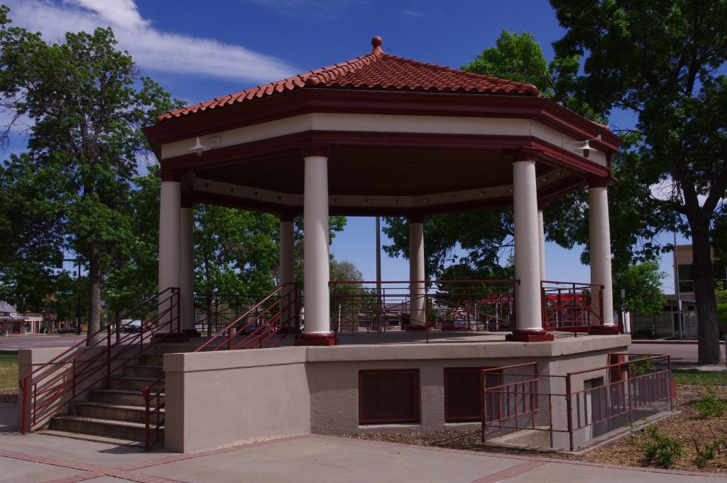 8-sided Gazebo with clay tile roof, round columns supporting canopy and 8 steps leading up to floor of Gazebo.