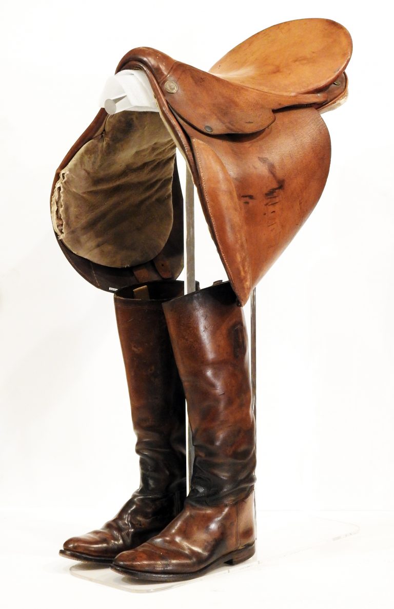 Raymond Lewis’s Riding Boots and Saddle, ca. 1930. Generously Donated by Karine Kuehn, 2019.79.1, .2.