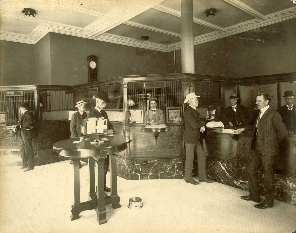 Winfield Scott Stratton, Henry McAllister and Henry Howbert conduct their banking at the First National Bank of Colorado Springs, 1902. Generously donated by William A. Doherty, A81-78-2.