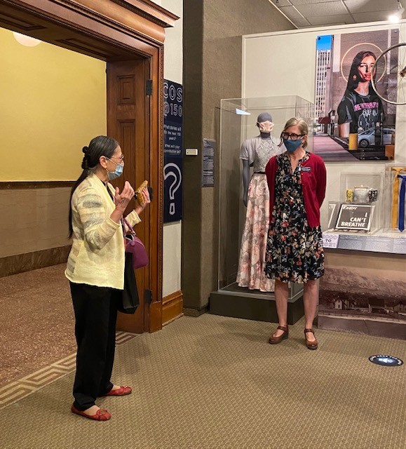 Cynthia Aki, member of the Golden Lotus Foundation, sharing about her involvement in the "COS@150" exhibit.