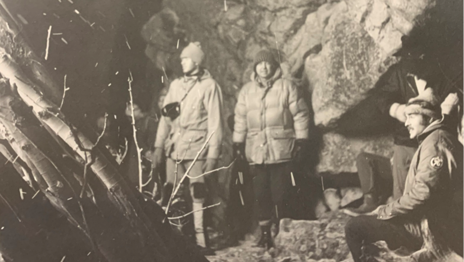 John Graham, right, enjoys a large bonfire and tall tales by his elders, 1976
