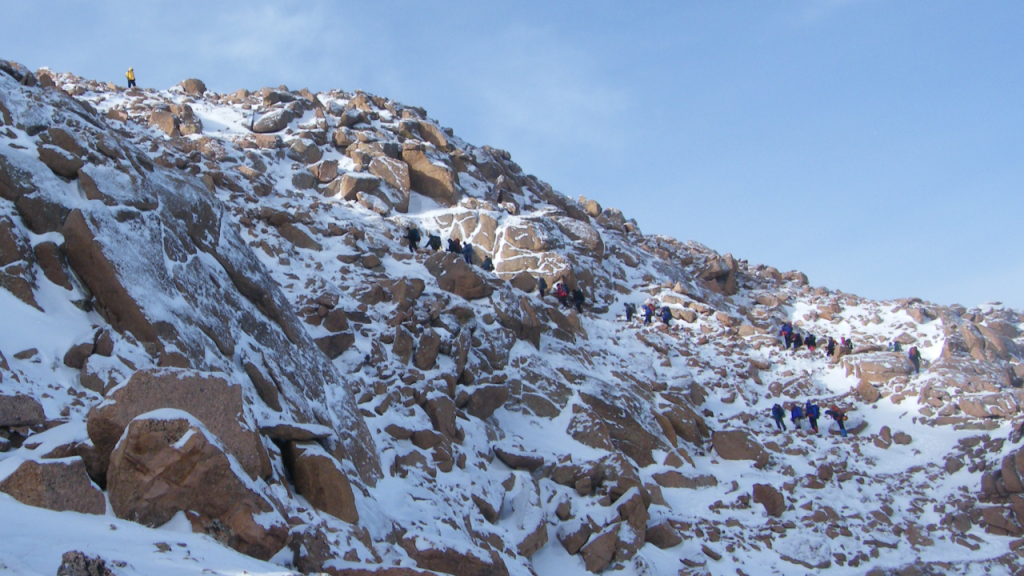 Glen Law waits to great climbers near the top of the stairs, 2012.