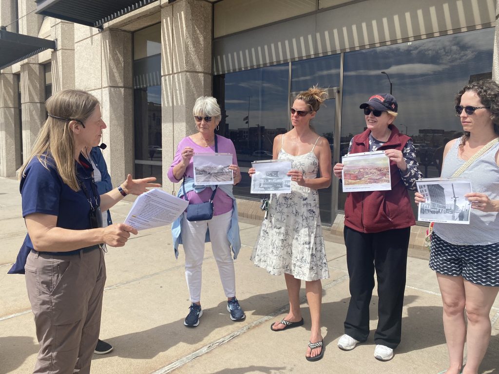Tanja Britton giving a history stroll tour to a group of attendees.
