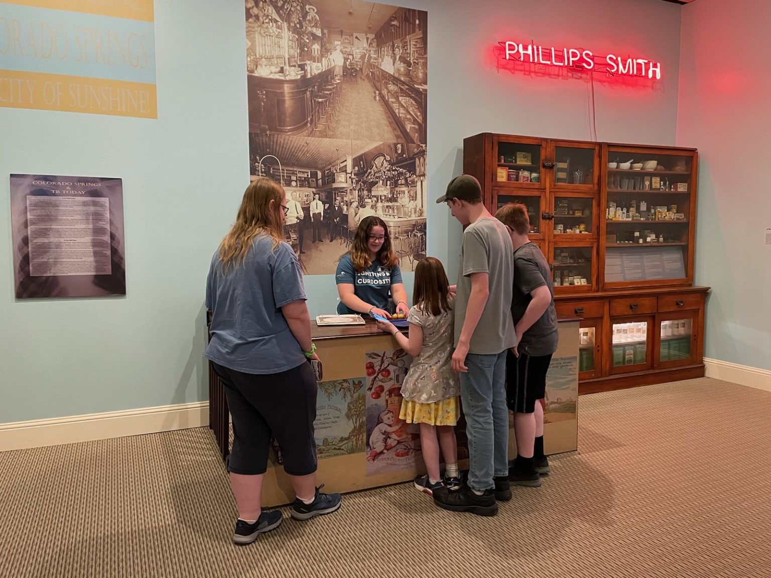 Junior Docent sharing history with a family.