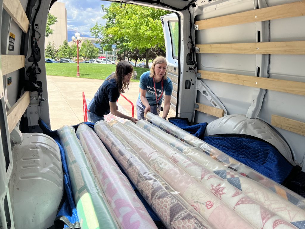 CSPM staff are carefully moving quilts from the historic courthouse to the offsite storage facility.