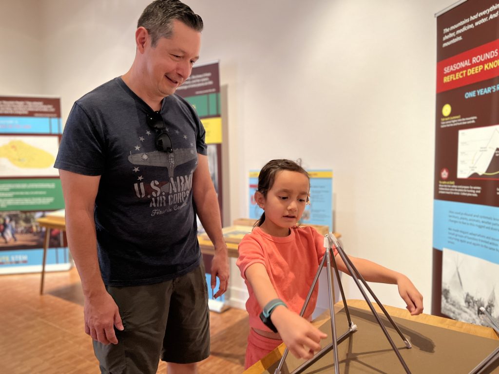 A father and daughter explore the Ute STEM exhibit at the CSPM annex
