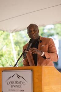 Mayor Yemi Mobolade speaking at the podium at the Gift of History event.