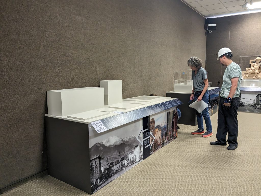 Kelly Murphy, Exhibit Designer, and Alex Archuleta, Museum Technician, work on deinstalling a portion of the COS@150 exhibit for the HVAC renovation.