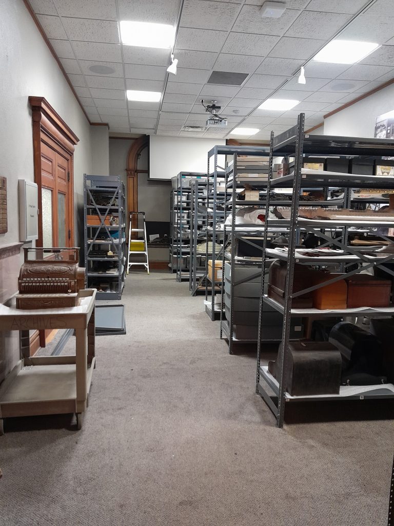 Rows of shelves holding artifacts from the CSPM collections in the Henderson Gallery.
