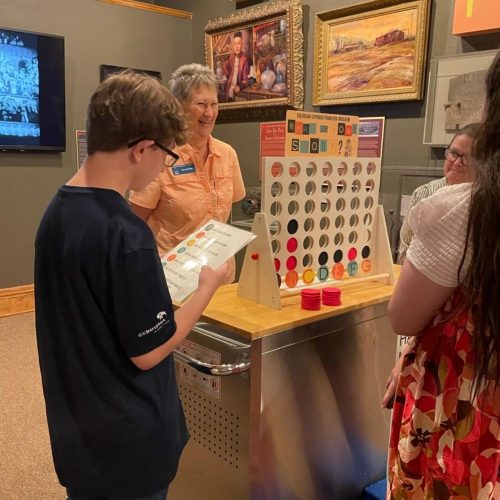 Nancy Bernard, CSPM Vice President and Volunteer, participates in the Connect 4 activity during the Summer Family Fun Day. Photo courtesy of CSPM.