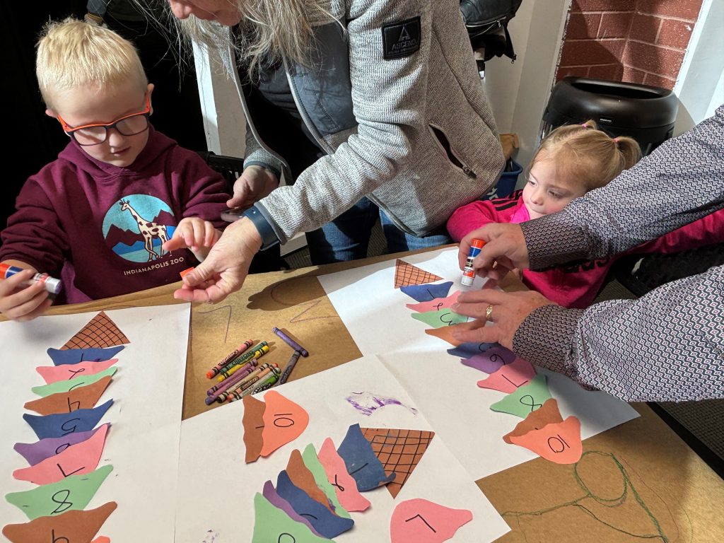 Little Learners and their favorite adults working on crafts in the CSPM Annex Makerspace.