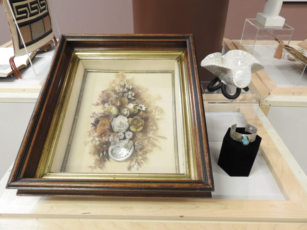 Museum case; Vintage florals in shadowbox, ceramic bowl, silver cuff (left to right).