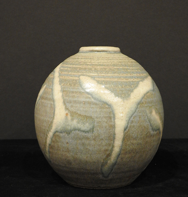 Clay sculpted vase with abstract glaze streaks.