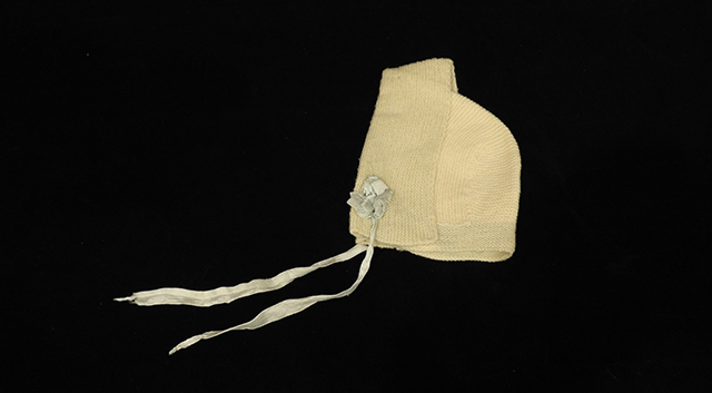 Hand Knit Baby Bonnet with Blue Ribbon, Belonged to Emily Lawton, 1870-1900, Generously Donated by Helen Gilmore, Unknown.