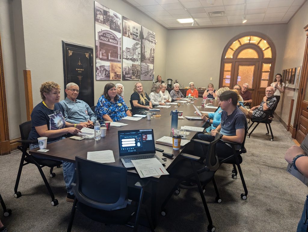 Gallery Attendants sitting around a conference training for a volunteer training.