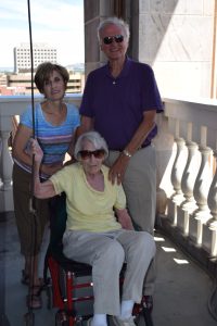 Helen McCaffrey ringing the Clock Tower bell with Nita and Nathaniel Peters.