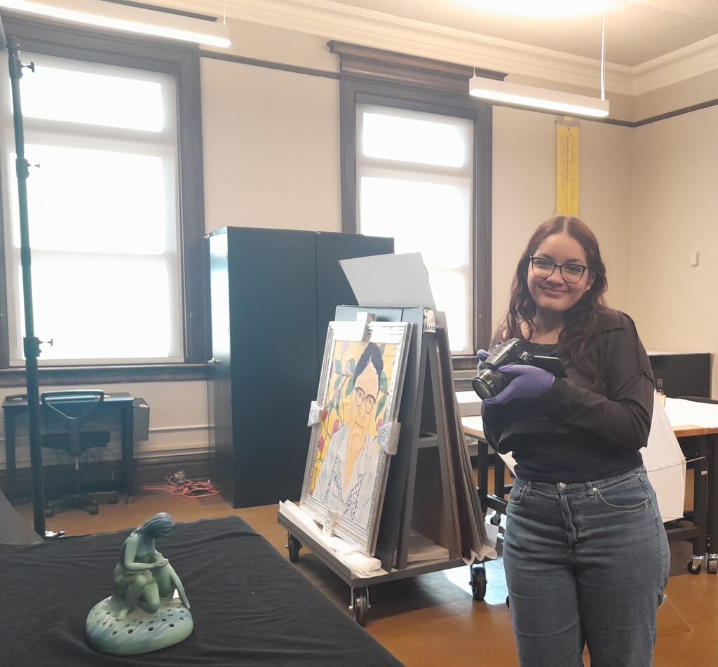Collections intern Samirah is standing in the collections processing area of the museum.